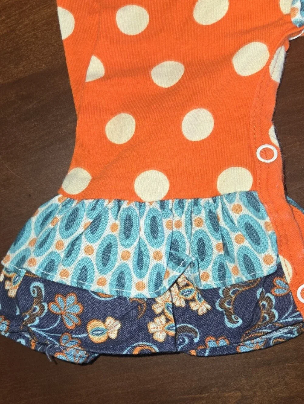 Girls Orange Polka Dot Ruffle One-Piece Bodysuit with Blue Floral Trim